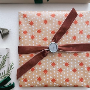 silver Northstar oval mini wax seal decorated on Christmas gift
