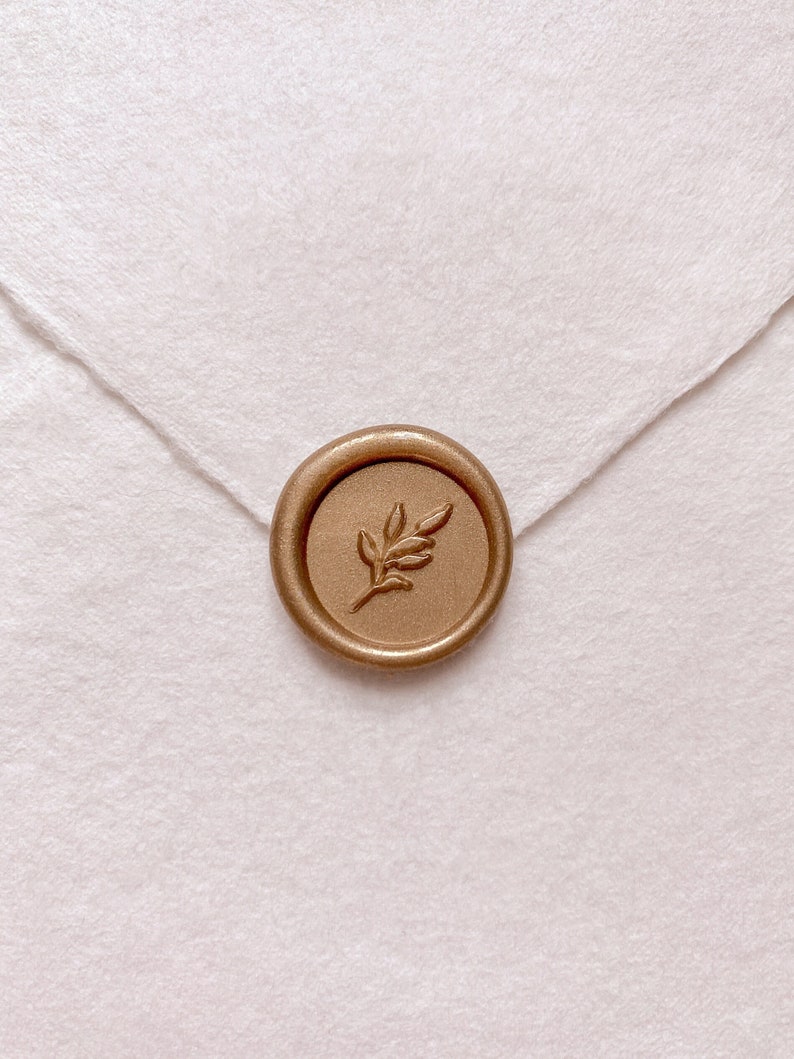 Leaf design mini gold wax seal on white handmade paper envelope