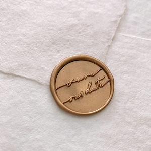 Calligraphy script Save our Date gold wax seal on white handmade paper envelope, side view