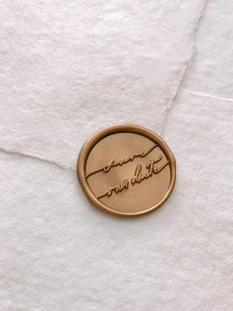Calligraphy script Save our Date gold wax seal on white handmade paper envelope, side view