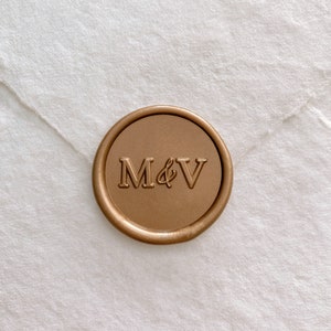 Monogram self-adhesive wax seal in gold on white handmade paper envelope