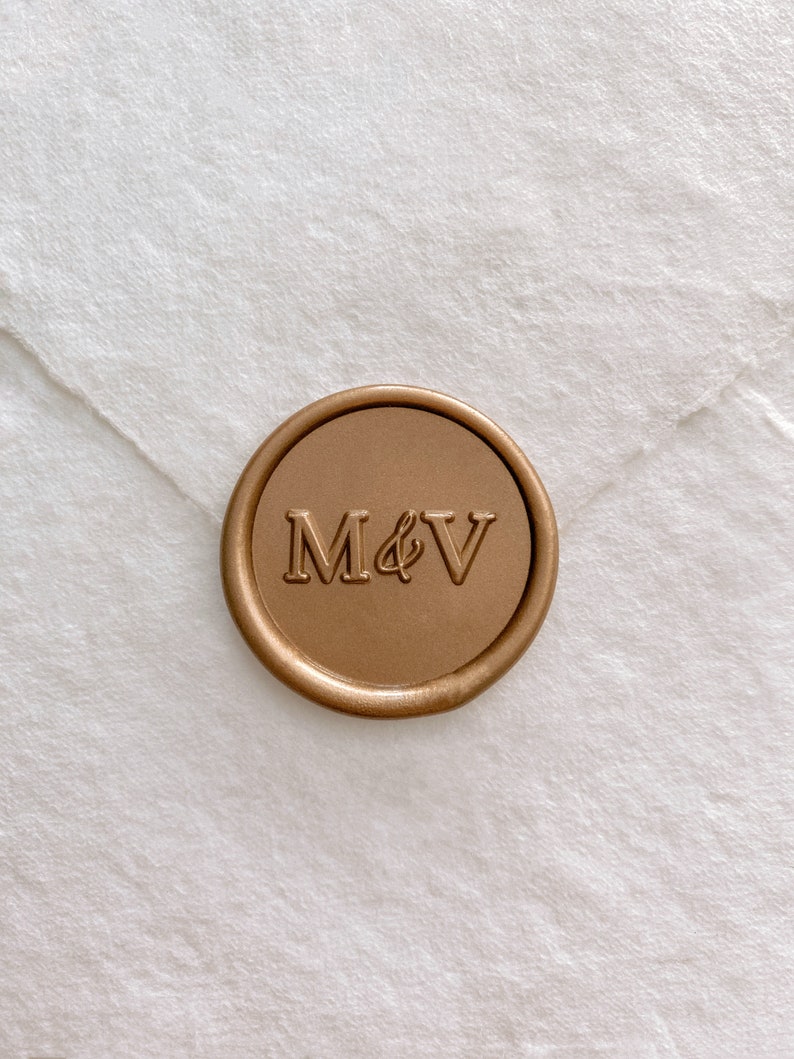 Monogram self-adhesive wax seal in gold on white handmade paper envelope