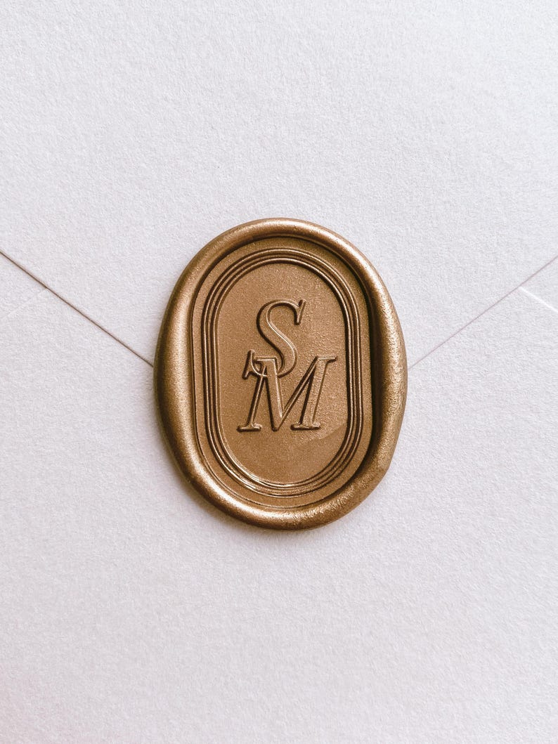 Oval border design personalized initials gold wax seal on a white envelope