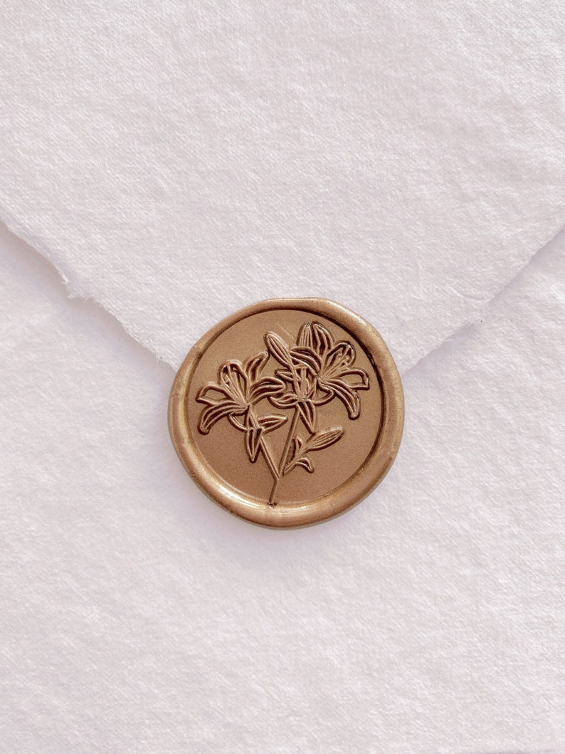 Gold lily flower wax seal on white handmade paper envelope