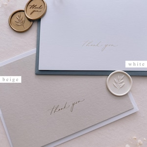beige and white thank you note cards gold foil printed, accompanied with envelopes and wax seals