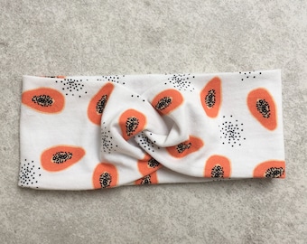 May include: White headband with a papaya print. The headband is twisted and has a knot in the center.