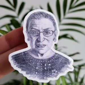 May include: A black and white pencil drawing of a woman wearing glasses and a patterned shirt. The drawing is on a white background.
