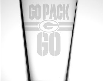 May include: A clear glass beer stein with a white etched design that says "GO PACK GO" with the Green Bay Packers logo in the middle.