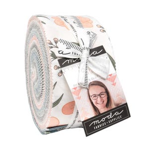 May include: Rolled fabric bundle featuring a floral pattern in shades of peach, green, and blue on a white background. The bundle is tied with a white ribbon and a tag with the text "moda FABRICS + SUPPLIES".