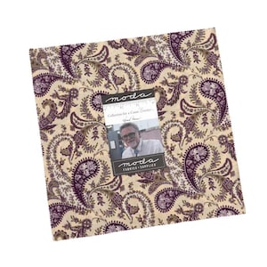 May include: A square fabric piece with a paisley pattern in cream, purple, and brown. The fabric has a repeating design of swirling paisley shapes. A small tag with text and a photo is attached to the fabric. The tag reads "moda FABRICS + SUPPLIES".