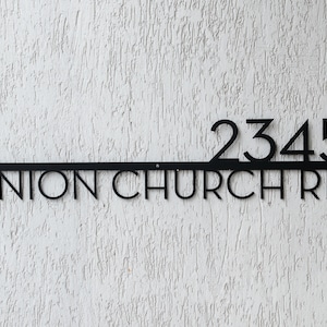 May include: Black metal house number sign with the address 2345 Union Church Rd.