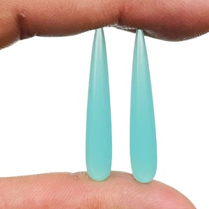 May include: Two teardrop-shaped turquoise gemstone beads.