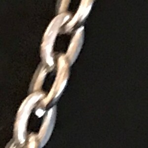May include: A silver chain necklace with a classic link design.