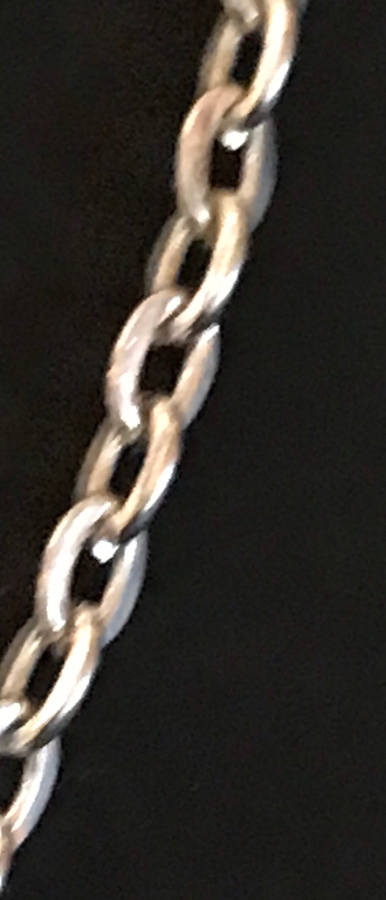 May include: A silver chain necklace with a classic link design.