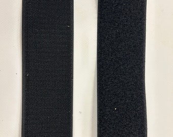 May include: Two strips of black hook and loop fastener, also known as Velcro. The strips are side by side on a white background.