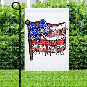 May include: A white garden flag with a red, white, and blue American flag design. The flag has a bow on top and the text "Stars and Stripes" in black lettering.