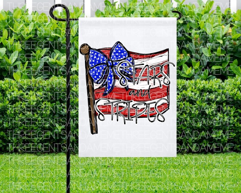May include: A white garden flag with a red, white, and blue American flag design. The flag has a bow on top and the text "Stars and Stripes" in black lettering.