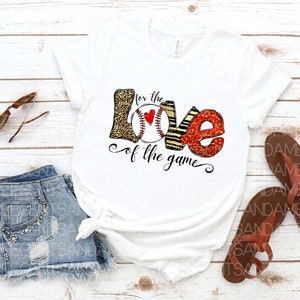 May include: White t-shirt with a graphic of a baseball with the words "for the love of the game" printed on it.