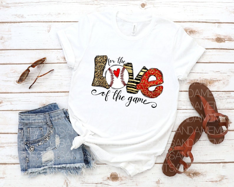May include: White t-shirt with a graphic of a baseball with the words "for the love of the game" printed on it.
