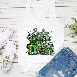 May include: White tank top with a green and gold graphic that says "Eagles Drill Team" with a cheerleader's pom pom and boots.