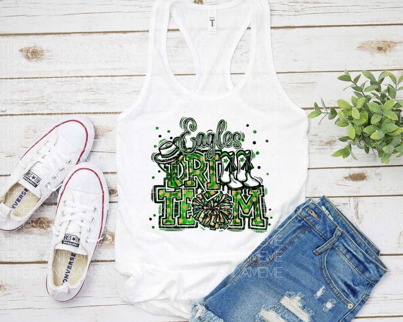May include: White tank top with a green and gold graphic that says "Eagles Drill Team" with a cheerleader's pom pom and boots.