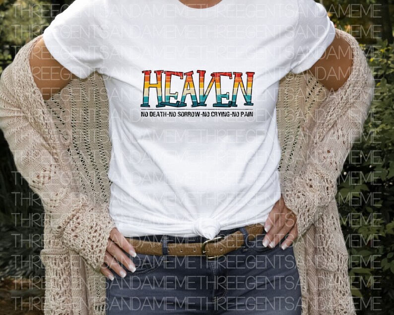 May include: A white t-shirt with a rainbow-colored graphic that says "HEAVEN" and the text "NO DEATH-NO SORROW-NO CRYING-NO PAIN" underneath.