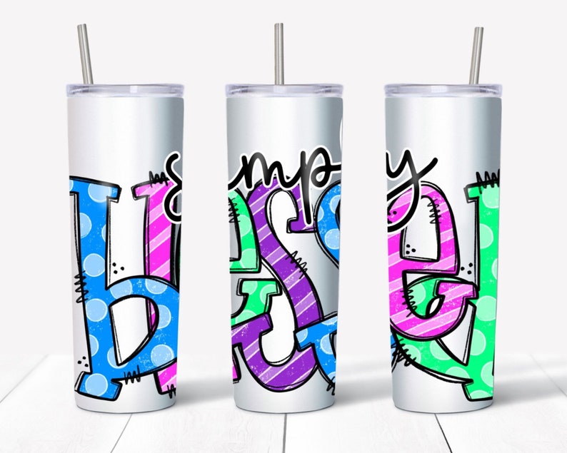 May include: Three stainless steel tumblers with a white background and colorful lettering that reads "simply blessed". The letters are outlined in black and have a variety of patterns, including polka dots, stripes, and zigzags.