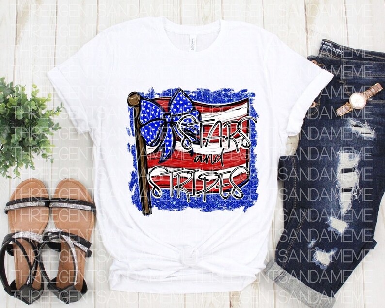 May include: White t-shirt with a distressed American flag design and the text "Stars and Stripes".