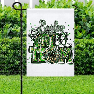 May include: A white garden flag with green and gold accents. The flag features the text "Eagles Drill Team" with a cheerleader pom-pom and a football helmet.