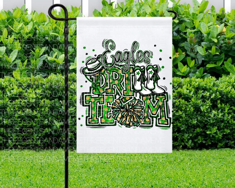 May include: A white garden flag with green and gold accents. The flag features the text "Eagles Drill Team" with a cheerleader pom-pom and a football helmet.