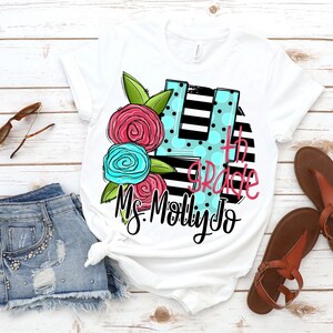 May include: White t-shirt with a black and white striped circle design. The circle has a large blue and pink flower design with a number 4 in the center. The text "4th Grade" and "Ms. Molly Jo" are written in black.