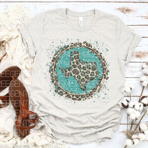 May include: A white t-shirt with a turquoise and brown graphic of the state of Texas with a leopard print design.