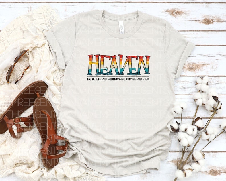 May include: A white t-shirt with a rainbow-colored graphic that says "HEAVEN" and "NO DEATH-NO SORROW-NO CRYING-NO PAIN" in black text.