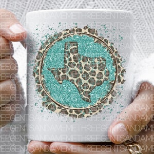 May include: White ceramic mug with a teal glitter and leopard print design of the state of Texas.