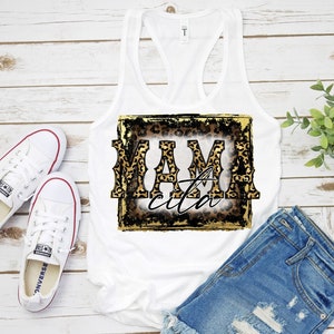 May include: White tank top with a leopard print graphic that says "Mamacita" in a gold and black font.