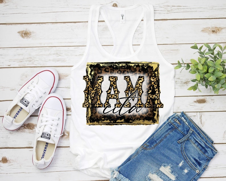 May include: White tank top with a leopard print graphic that says "Mamacita" in a gold and black font.