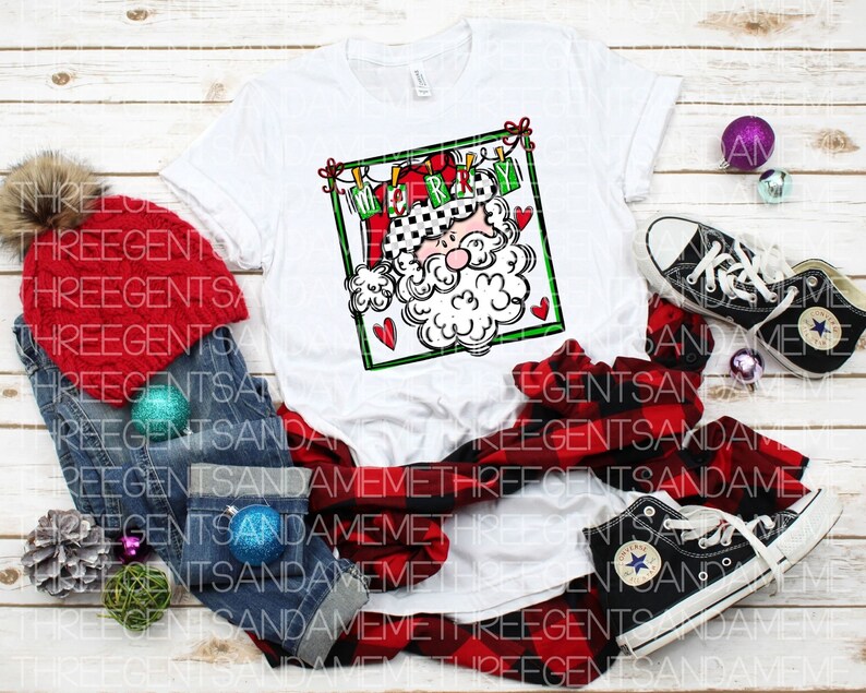 May include: White t-shirt with a red and green illustration of Santa Claus with the text "Merry Christmas" above him.