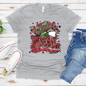 May include: Gray t-shirt with a red, white, and green graphic that says "Wheeler Baseball" with a baseball and bat.
