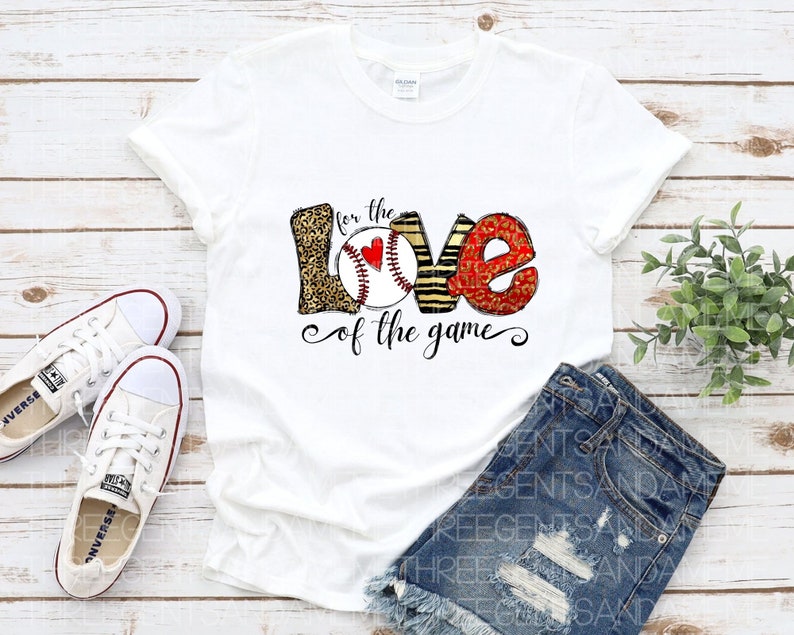 May include: White t-shirt with a graphic design of the word "love" with baseballs incorporated into the letters. The text "for the love of the game" is below the graphic.