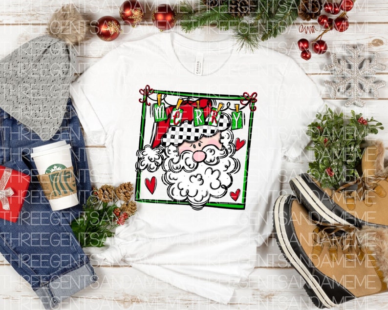 May include: White t-shirt with a black and white illustration of Santa Claus wearing a checkered hat and holding a sign that says "Merry". The illustration is surrounded by a red and green frame with hearts.