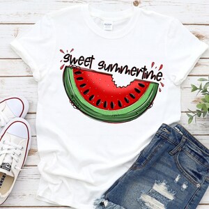 May include: White t-shirt with a red and green watermelon graphic and the text "Sweet Summertime".