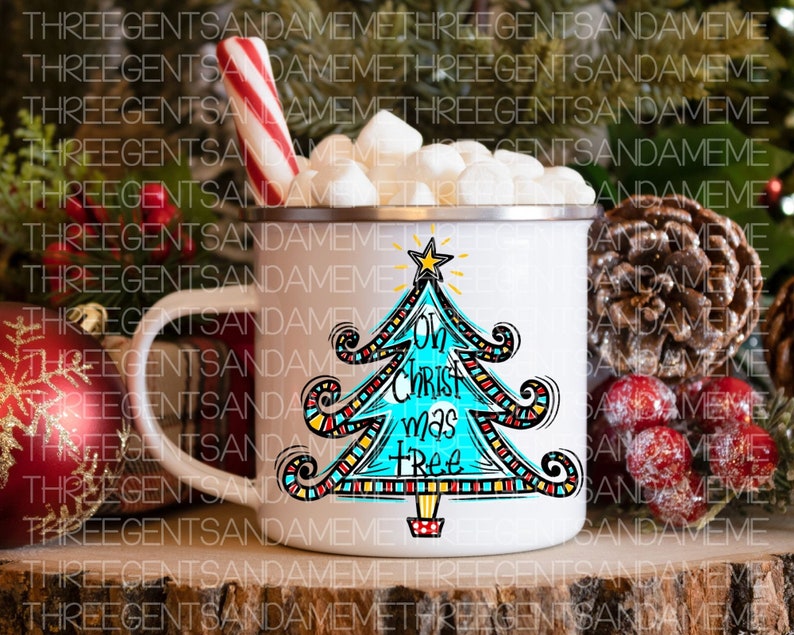 May include: White ceramic mug with a blue and red Christmas tree design. The tree has the words "Oh Christ mas tree" written on it. The mug is filled with marshmallows and a red and white candy cane.