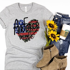 May include: Gray t-shirt with a red, white, and blue heart design that says "Airforce wife".