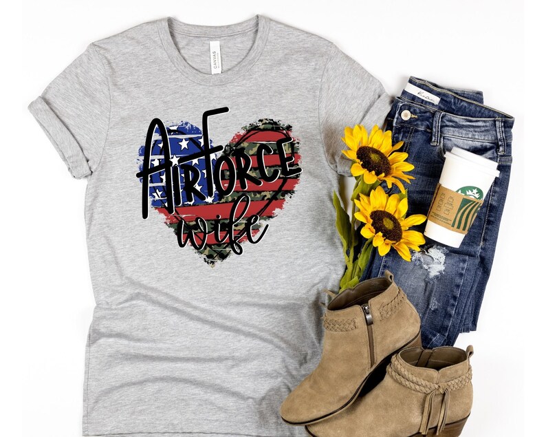 May include: Gray t-shirt with a red, white, and blue heart design that says "Airforce wife".