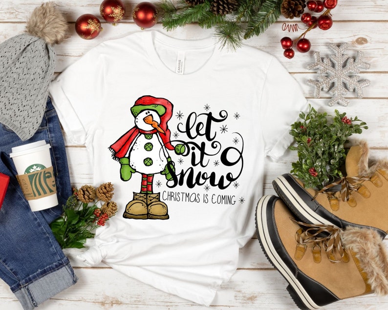 May include: White t-shirt with a snowman graphic and the text "Let it snow. Christmas is coming."