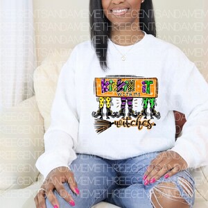 May include: White sweatshirt with a graphic of witches with the text "Kickin' it with my witches".