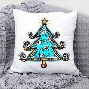 May include: White cushion with a colourful, hand-drawn Christmas tree design. The tree is blue and decorated with red, yellow and black stripes. The text "Oh Christ mas tree" is written on the tree.