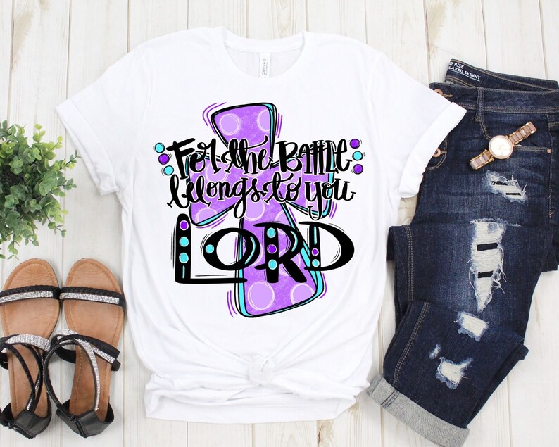 May include: White t-shirt with a purple cross and the text "For the battle belongs to you LORD" in black.
