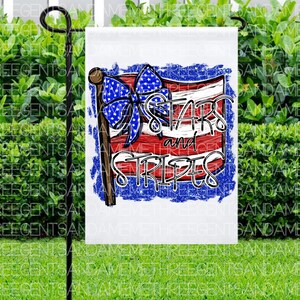 May include: A white garden flag with a red, white, and blue American flag design. The flag has a blue bow and the text "Stars and Stripes" in a white, blue, and red font.
