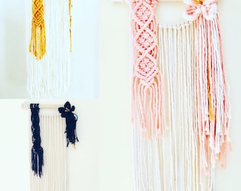 May include: Three macrame wall hangings with different colored yarn. The first is yellow and white, the second is pink and white, and the third is black and white.